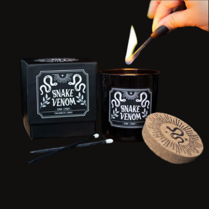 Snake Venom dark opium scented candle in a black jar with matching box on a charcoal background
