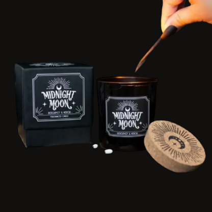 Midnight Moon bergamot and neroli scented candle in a black jar and box on a charcoal background